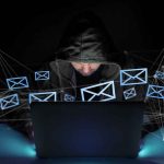 Family Fled Their Home TWICE Over Threats — Look WHO’s Accused Hooded person using a laptop surrounded by email icons