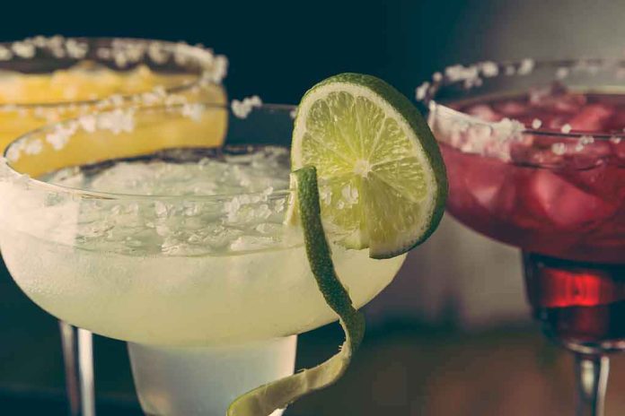 shutterstock_1051209227 Margarita glasses with salt rims and lime garnish