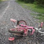 JUDGES Just Took 20,000 Off The Predator List — Victims Had NO Say Pink children's bicycle with training wheels lying on a gravel path