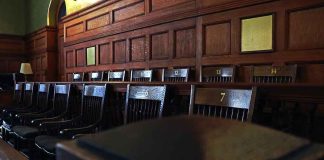 Six Dead At 130 MPH, A Pregnant MOM Among Them — The Jury Is BACK Empty wooden jury box with numbered chairs