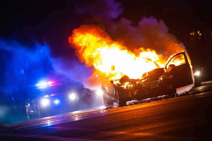 shutterstock_1133386718 Burning car on a dark street at night