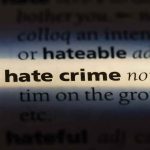 Jewish Man ATTACKED — What He Did The Very NEXT Day Close-up of dictionary page highlighting the term hate crime