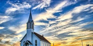 State BLOCKS A Church. Supreme Court Now Steps In White country church with steeple at sunset
