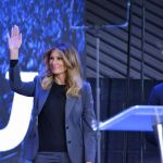 Shocking Health Gap Exposed — Melania Spotted It Melania Trump waves on stage beside Eric Bolling at an event