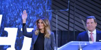 Shocking Health Gap Exposed — Melania Spotted It Melania Trump waves on stage beside Eric Bolling at an event