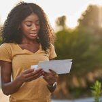 Biden Overcharged You For YEARS — What Trump JUST DID About It Woman checking mail at a roadside mailbox