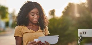 Biden Overcharged You For YEARS — What Trump JUST DID About It Woman checking mail at a roadside mailbox