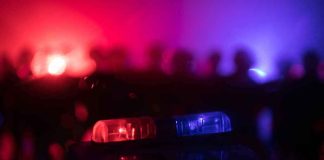 Police car light bar flashing red and blue at night