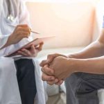Silent Threat Hits Men HARDEST — Even Fit Men Aren’t SAFE Doctor consulting a patient on a sofa