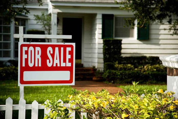 For sale sign in front of a suburban house