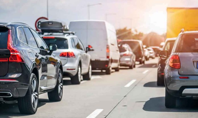 shutterstock_1680948604 Traffic jam with cars and vans on a multi-lane highway
