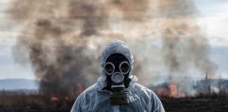 Families FLED In The Night — What The Fog Was HIDING Person in hazmat suit wearing gas mask amid smoke