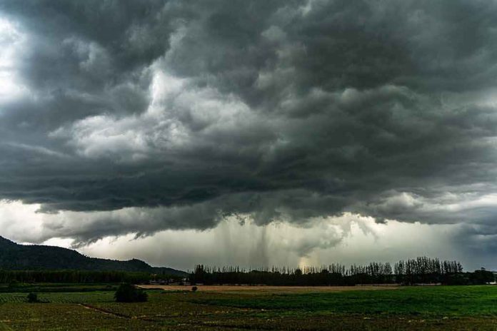Dark storm clouds over a rural field