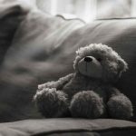 Couple ACCUSED Of DESPICABLE Abuse teddy bear on a sofa