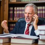 Democrat Governor Throws A Tantrum — His Excuse DEFIES Reason Older man in suit arguing on phone at desk with law books