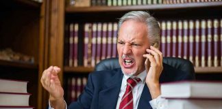 Democrat Governor Throws A Tantrum — His Excuse DEFIES Reason Older man in suit arguing on phone at desk with law books