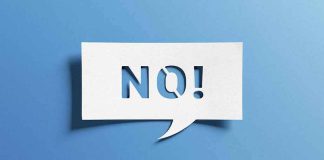 Speech bubble with cutout letters spelling NO! on blue background