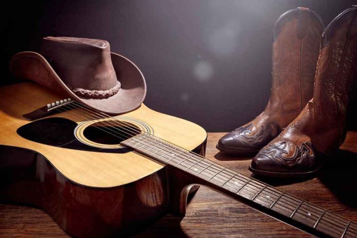 shutterstock_2217817375 Acoustic guitar with cowboy hat and leather boots on wooden table