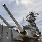 Old Warships FOOLED An Army — Where The REAL Attack Came From Close-up of a battleship's big naval guns and superstructure against a cloudy sky