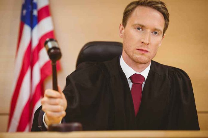 shutterstock_245624686 Judge holding a gavel in a courtroom