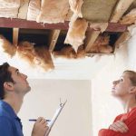 Contractor Gets 30 YEARS — His Timing Was SHAMELESS Two people inspecting a damaged ceiling with exposed insulation