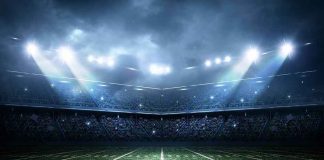 Football stadium field under bright night lights