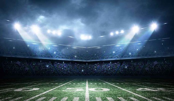 Football stadium field under bright night lights