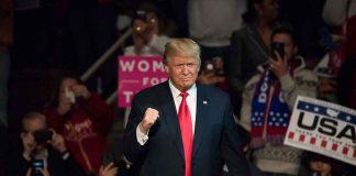 German Luxury BOSS Joins Trump — What He’ll Build HERE Donald Trump at a rally raising his fist amid a cheering crowd