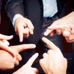 Group of hands pointing fingers at each other