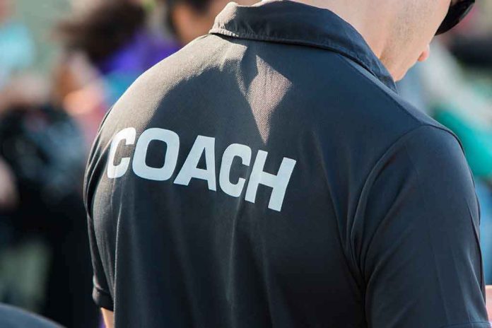 shutterstock_582703915 Coach wearing a black shirt with bold lettering